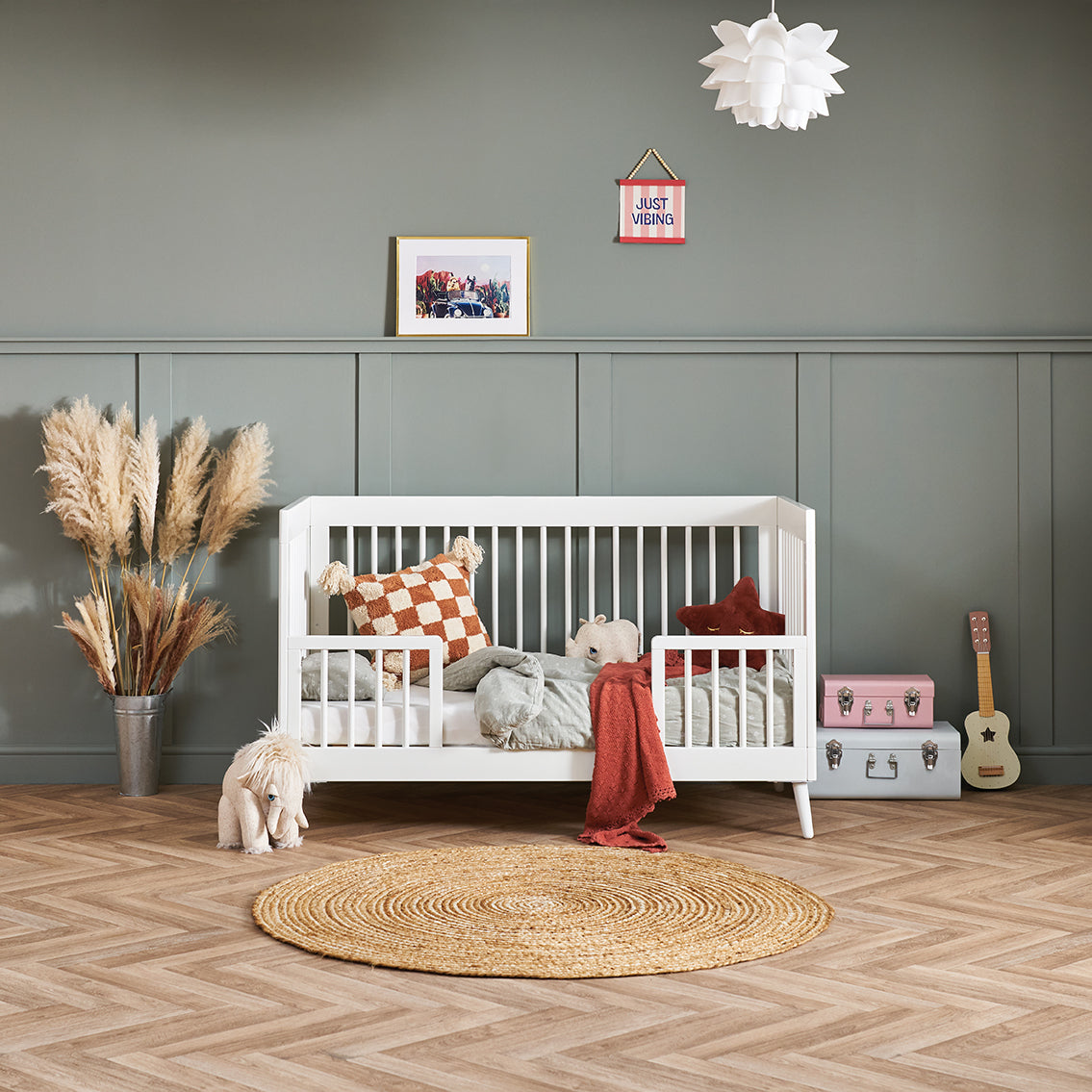 Cot bed with toddler safety rail. 