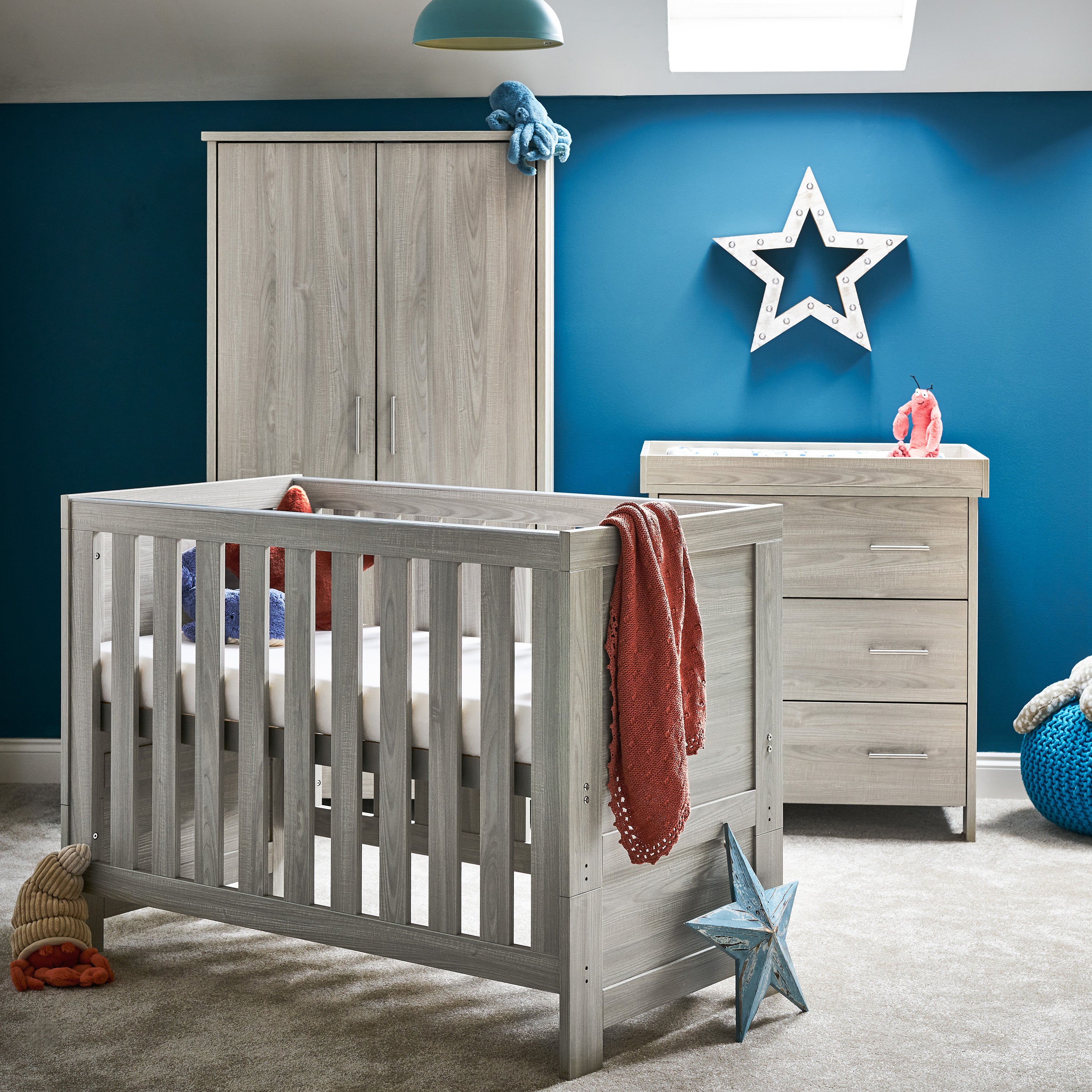 Mini Cot Bed Nursery Set, Cot Bed has solid end, changing unit has 3 drawers with metal handles & wardrobe has 2 doors with drawer at the bottom. 