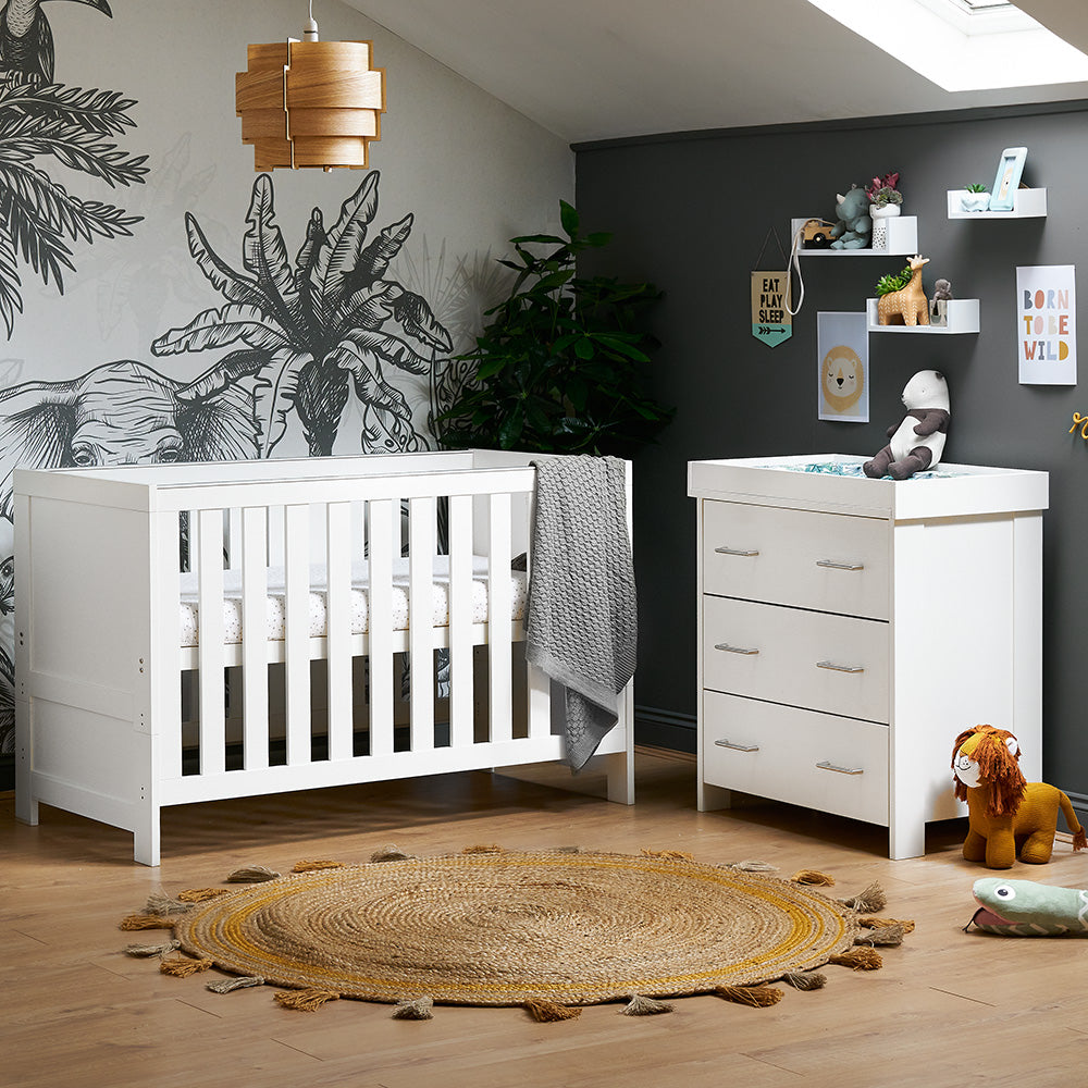 2 Piece nursery set includes cot bed with solid ends, wood style texture, teething rails & base on the new born setting. Matching Changing Unit has 3 drawers with metal handles & removable changing unit. 